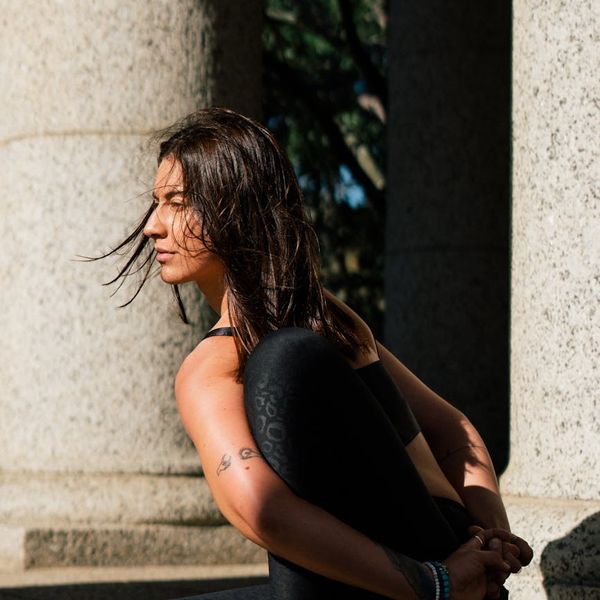 Person meditating peacefully outdoors during sunrise, symbolizing daily practice.